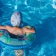 Boy floating in swimming pool