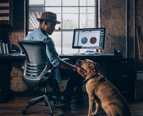Man with dog working from home