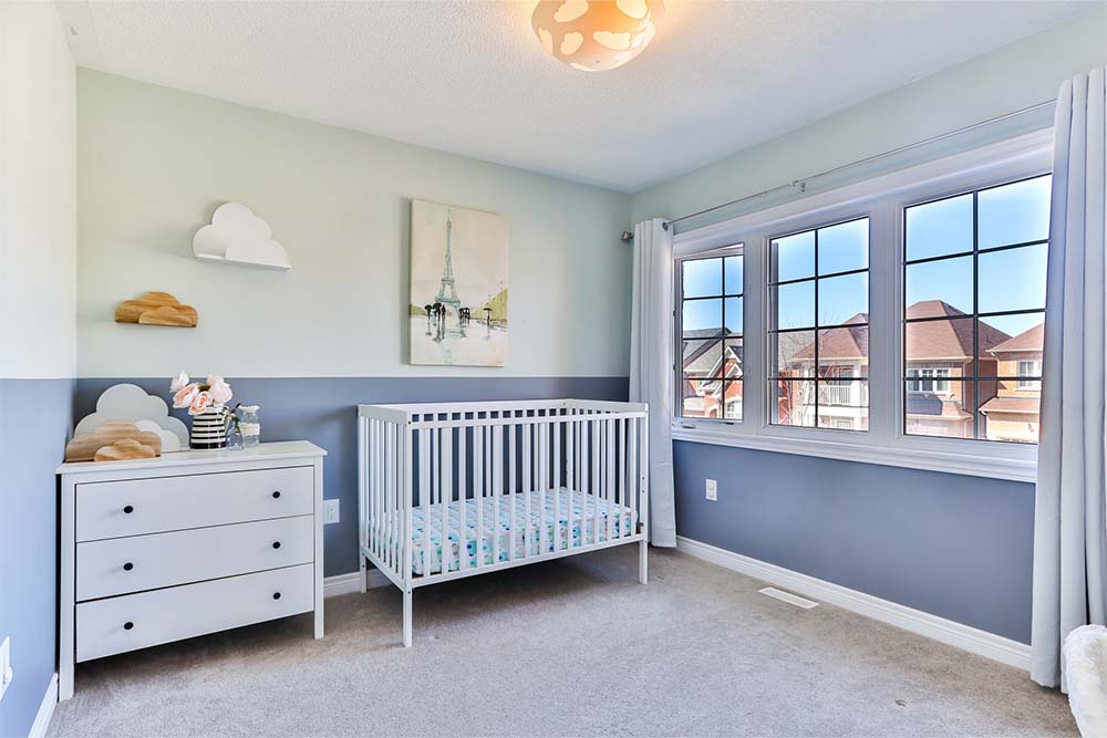 A room with baby furniture in it